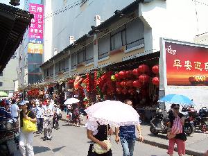 Szanghaj - Chinki chroniące się przed słońcem pod parasolami